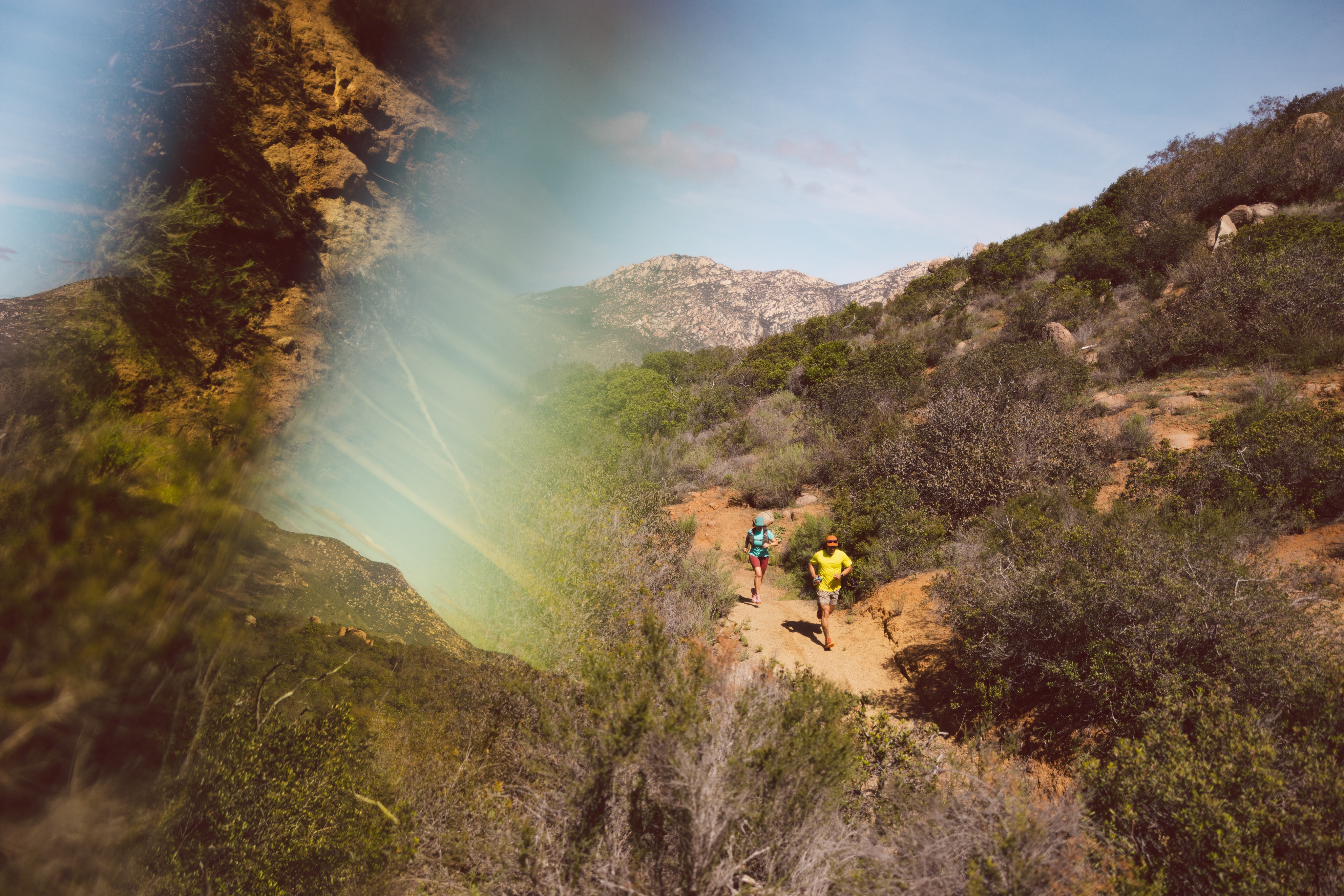 Image from above as two trail runners approach on a dirt path.