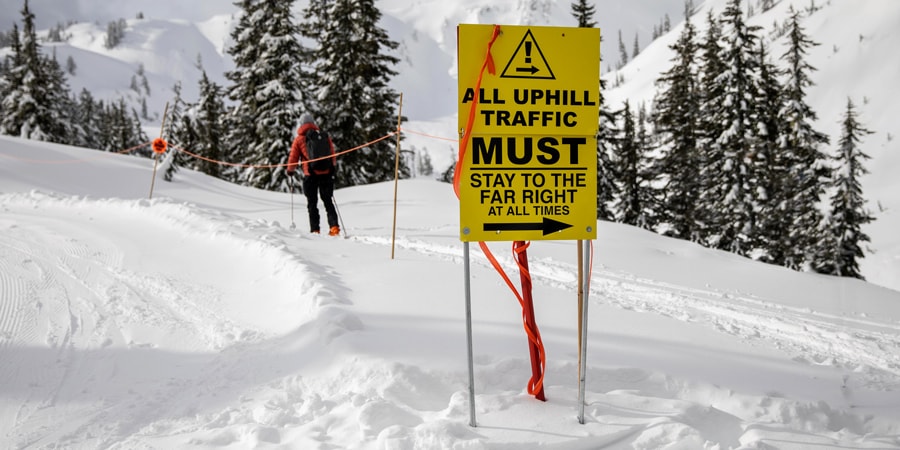 signage indicating where uphill skiers and snowboarder to ascend