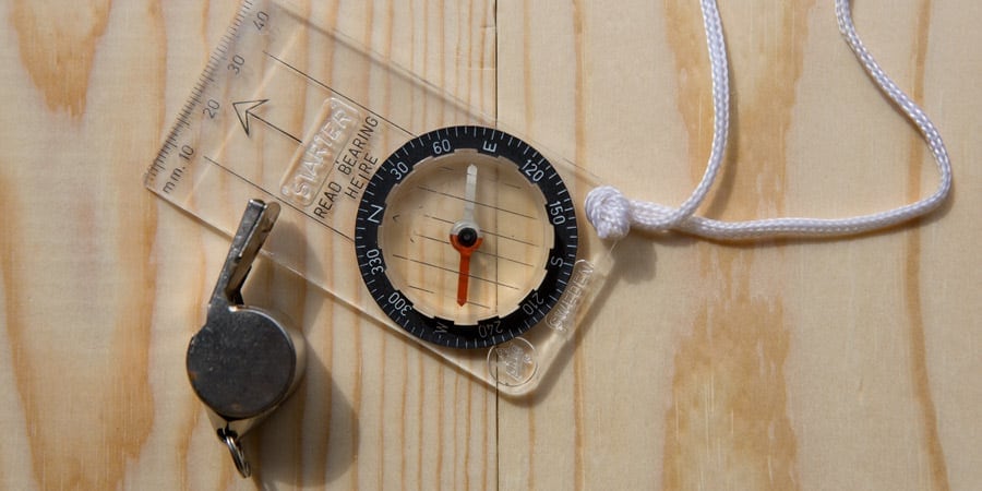 a simple baseplate compass and safety whistle for orienteering