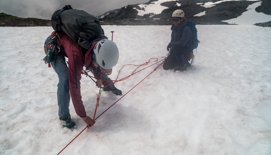 the rescue climber resetting the rescue system by pushing the prusik down the rope