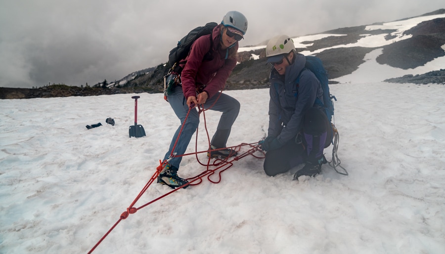 the rescue climber pulling on the rope to haul out the fallen climber