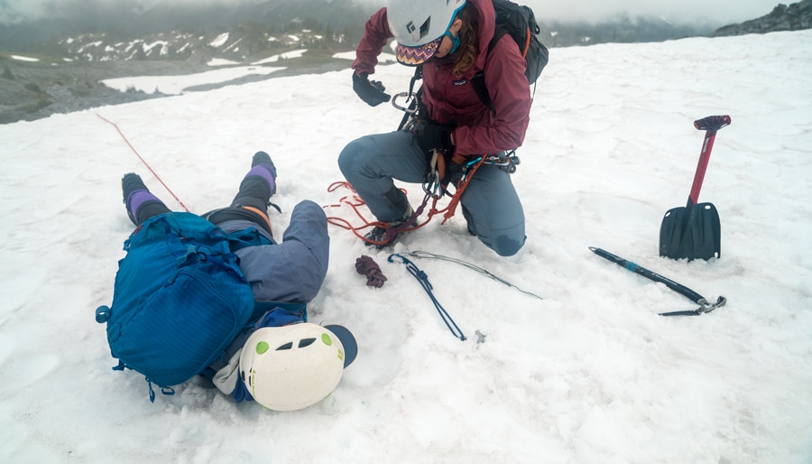 a mountaineer setting up an equalized anchor for crevasse rescue