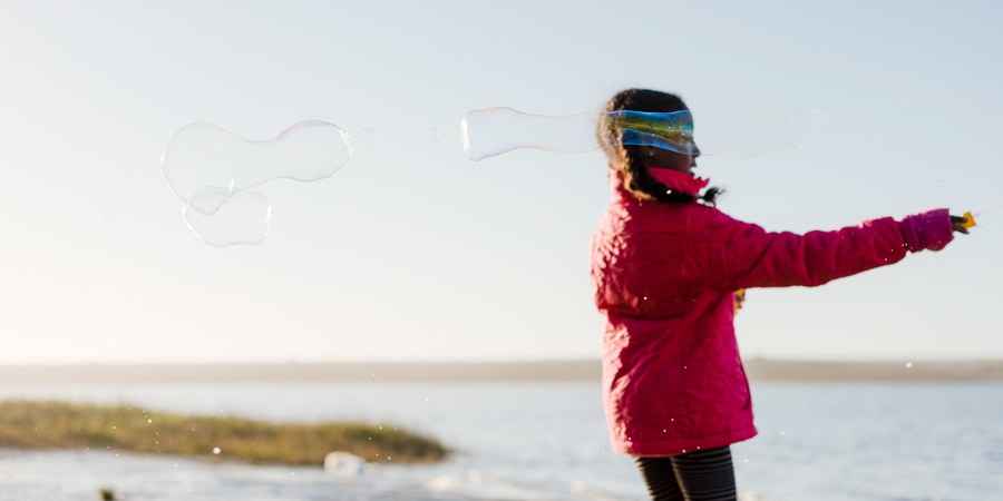 a young girl playing with bubbles along the coast