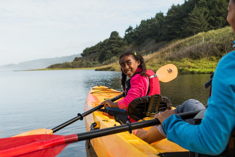 Picture of a teenage girl paddling.